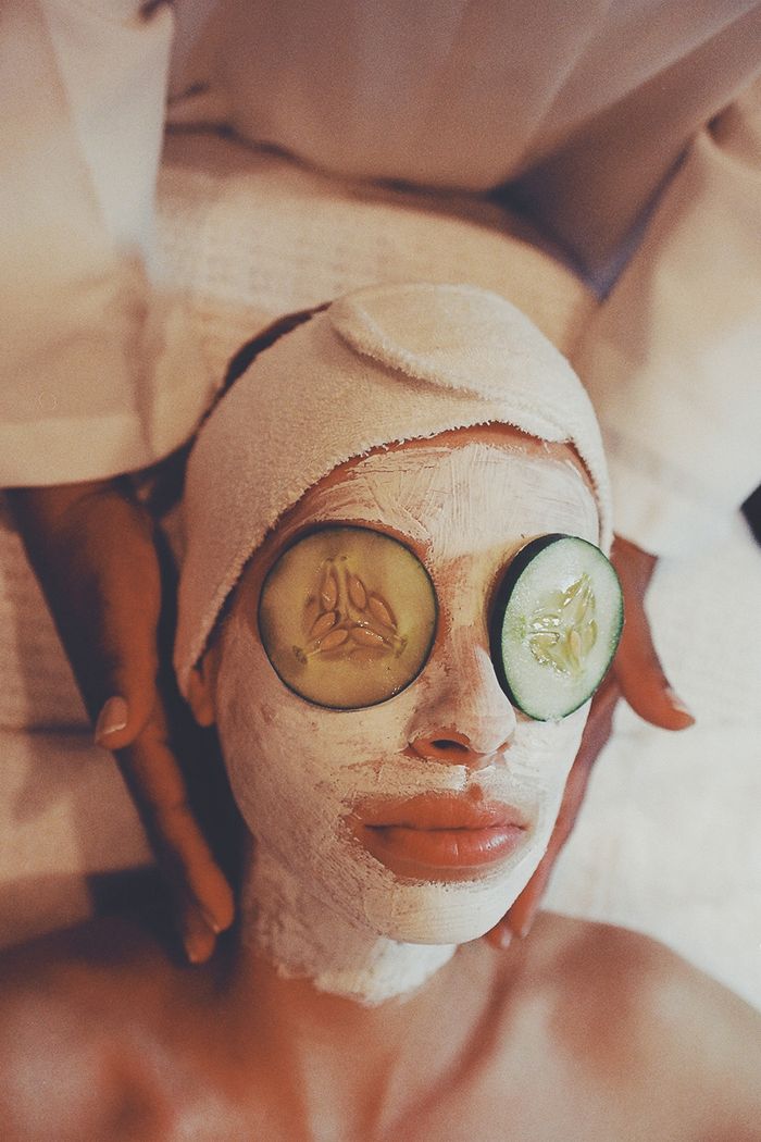 A calming spa scene with facial treatment, using cucumber slices and face mask.